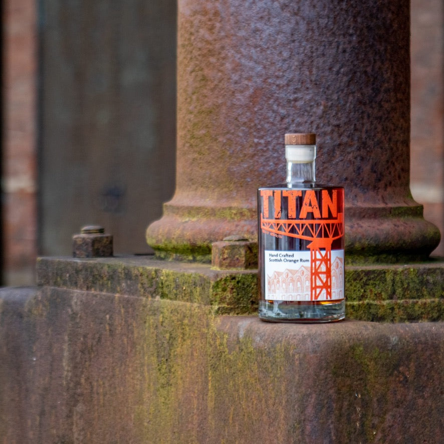 Bottle of Titan Hand Crafted Scottish Orange Rum on a Rusty Iron Pilar at the James Watt Dock Greenock