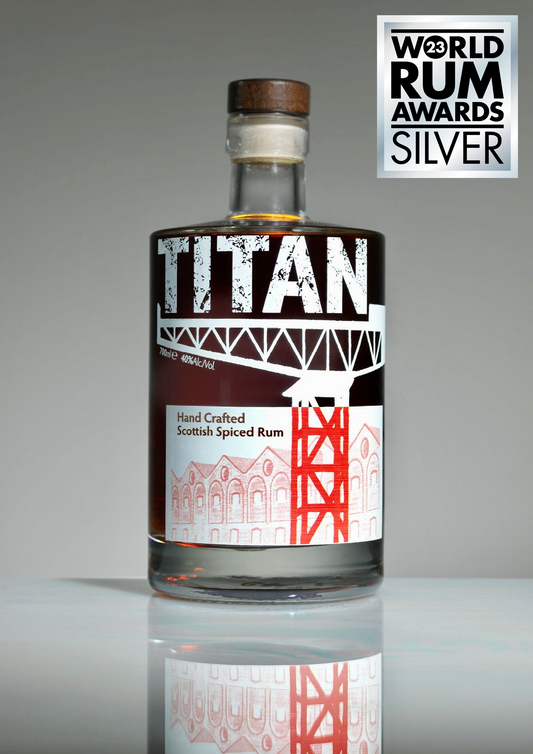 Titan rum bottle with a gray / white background and Silver World Rum Awards badge. White Label with the Titan crane and sugar sheds